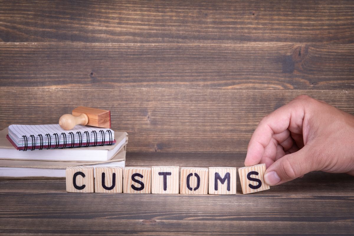 customs. wooden letters on the office desk, informative and communication background